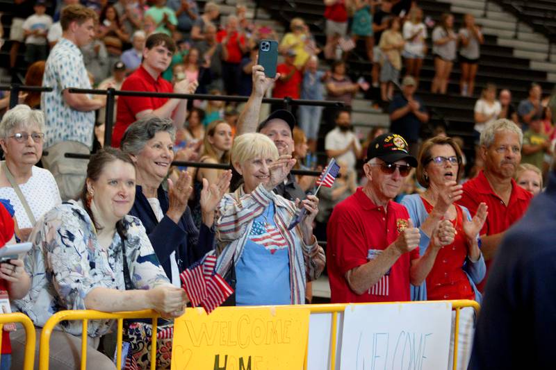 People offer a warm welcome as McHenry Community High School hosted a celebration Sunday for veterans returning from an Honor Flight trip to Washington D.C. The Honor Flight trip was coordinated by the Veterans Network Committee of Northern Illinois.