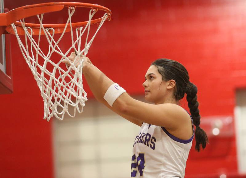 Serena's Paisley Twait cuts a piece of the net down after defeating Ashton-Franklin Center in the Class 1A Regional on Thursday, Feb. 15, 2024 at Earlville High School.