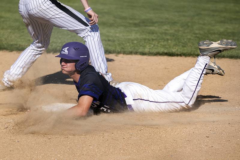 Dixon’s Brady Feit dives back to third safely against Freeport Thursday, May 23, 2024 during the Class 3A regional semifinal in Dixon.