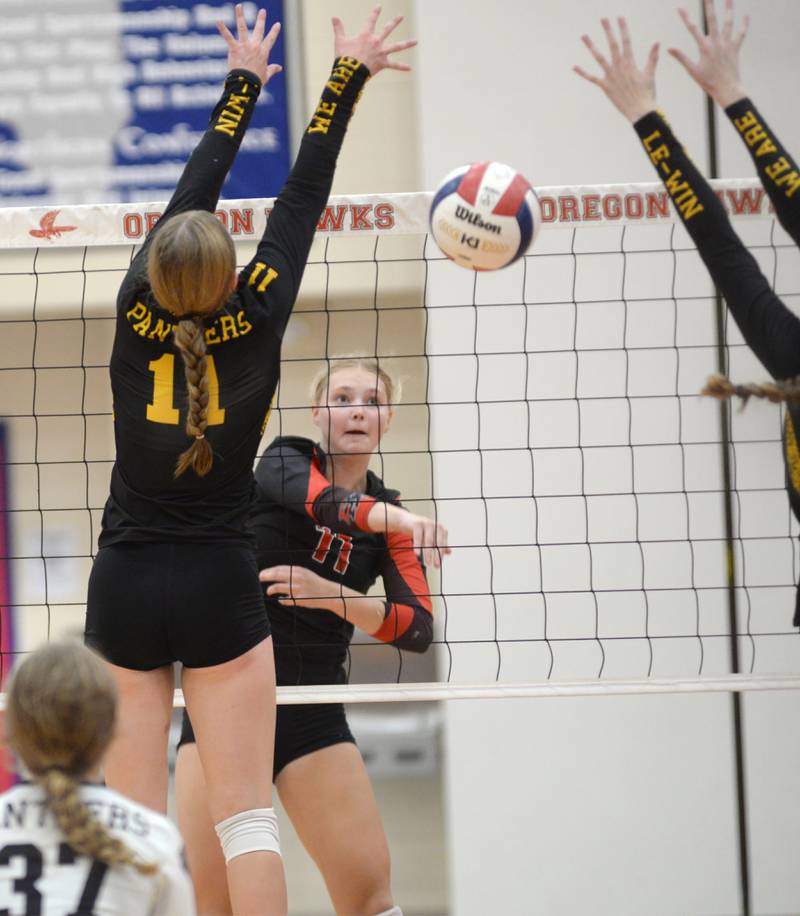 Erie-Prophetstown's Lauren Abbott (11) hits a spike between two Lena-Winslow players during the championship match of the Oregon Volleyball Tournament on Saturday, Sept. 7, 2024. The Panthers took the tournament title in three sets.