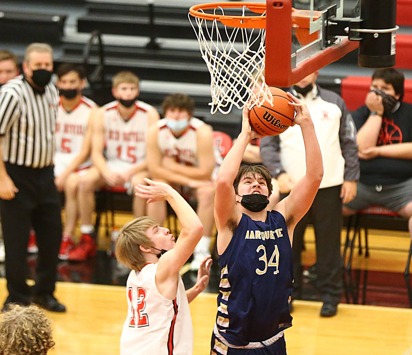 Marquette's Brady Ewers, (34) shoots a shot underneath the net over Hall's Ethan Plym, (12) during the 47th Colmone Classic tournament on Tuesday Dec. 7, 2021 at Hall High School in Spring Valley.