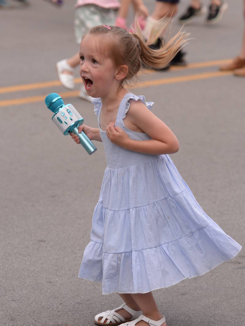 Children including Hannah Bethke of Glen Ellyn dance and sing to the sounds of Altered Suburbia during the concert held downtown Glen Ellyn Friday June 8, 2024.