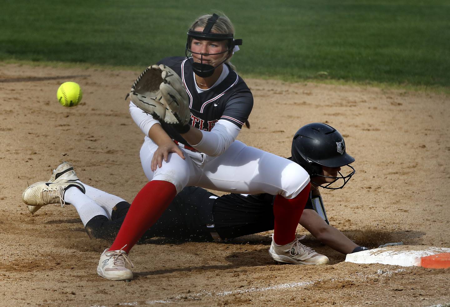 Huntley’s Meghan Ryan waits for the throw as Prairie Ridge’s Kendra Carroll dives back to first base during a Fox Valley Conference softball game on Monday, April 29, 2024, at Prairie Ridge High School.