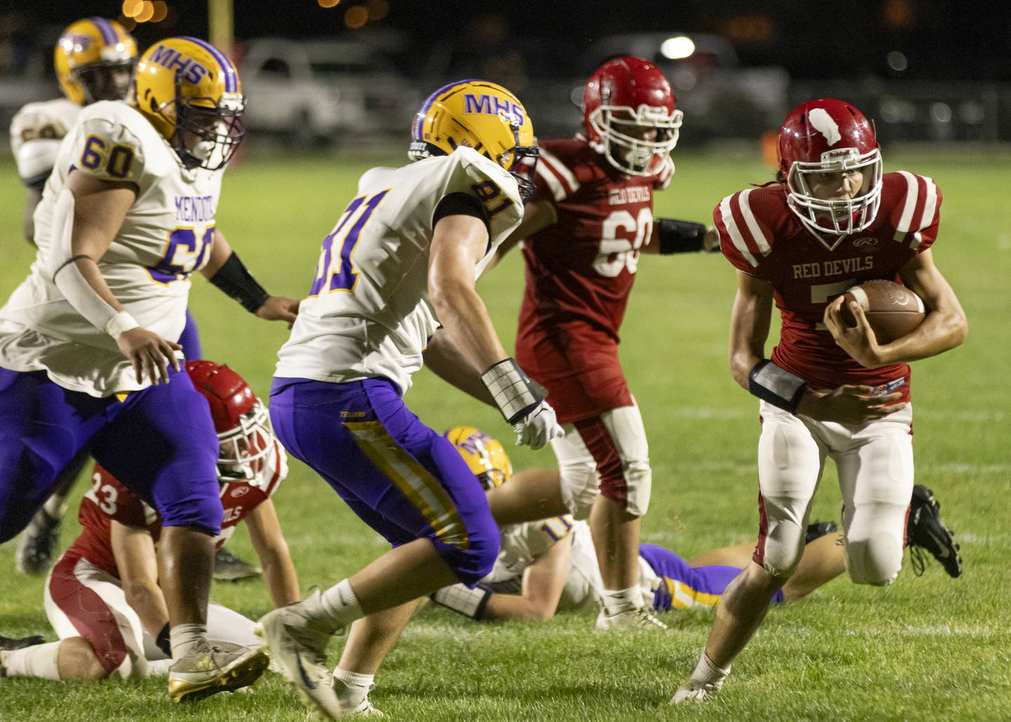 Hall quarterback Dylan Glynn runs the ball past Mendota defense to gain yards during the game at Richard Nesti Stadium on September 13, 2024.