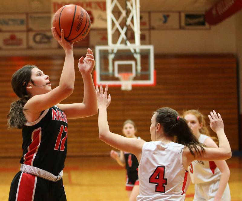 Henry-Senachwine's Kaitlyn Anderson (left) runs into the lane to shoot a shot over Streator's Kora Lane (right) on Wednesday, Jan,. 4, 2023 at Streator High School.