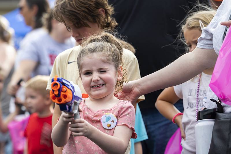 Jillian Good, 5, of Dixon takes aim Friday, July 5, 2024 during a family fun event for Petunia Fest. The event, held in the First Presbyterian Church parking lot, was jammed with families playing games and enjoying the pleasant evening weather.