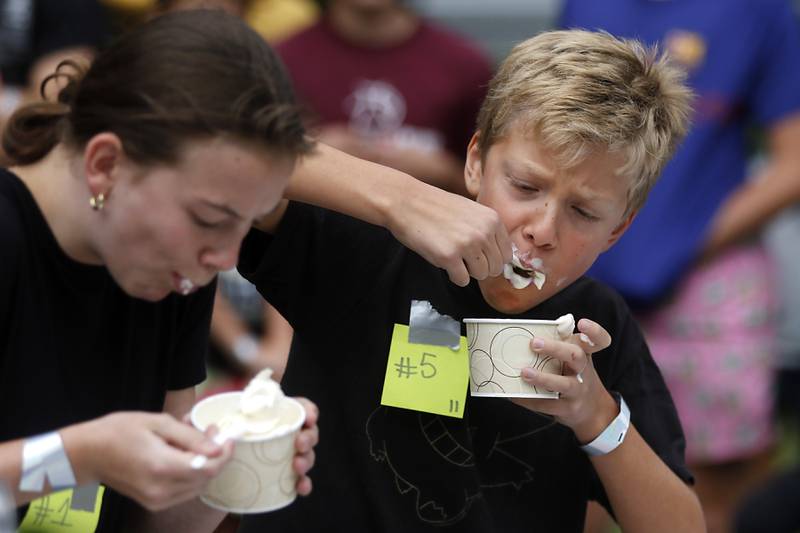 Casey Lindstrom shovels ice cream into his mouth on his way to winning his round of the Brain Freese Ice Cream Eatin’ Contest during the Ice Cream Fest on Friday, Aug. 9, 2024, at Crystal Lake’s Main Beach.  The second annual event featured music, ice cream venders and the ice cream eating contest.