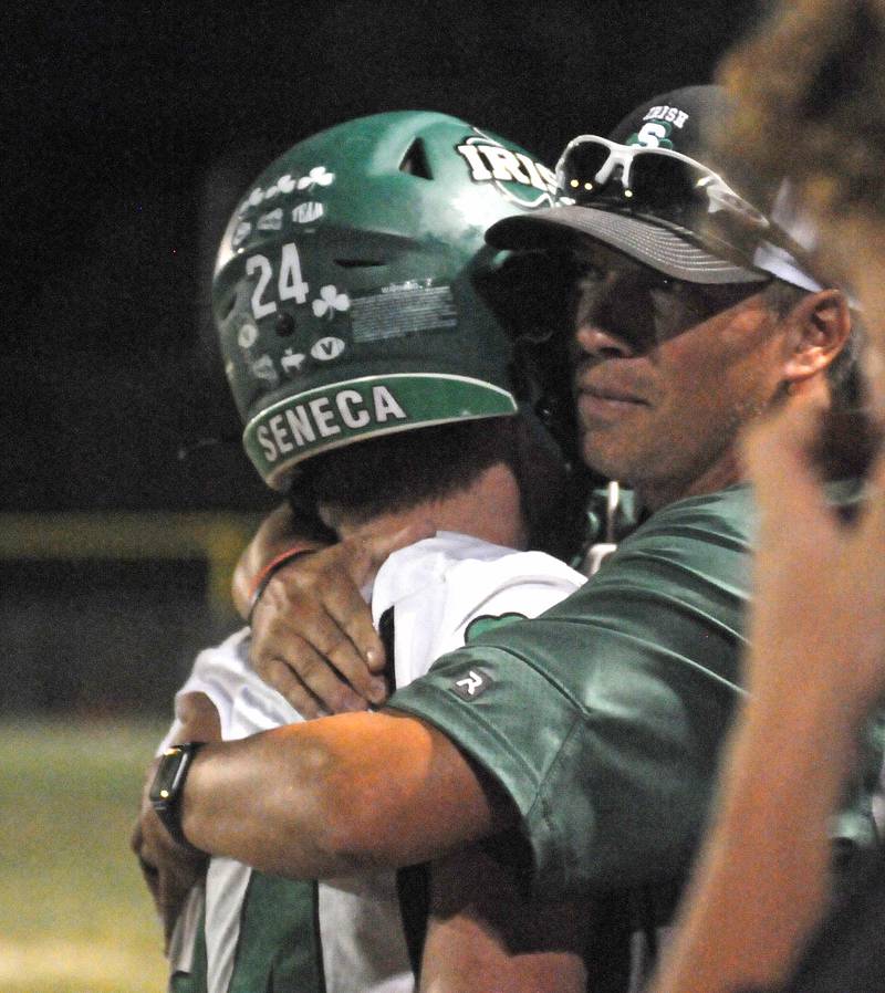 Seneca assistant coach Tim Brungard hugs running back Brody Rademacher after one of his touchdowns against Marquette at Gould Stadium on Friday, Sept. 13, 2024.