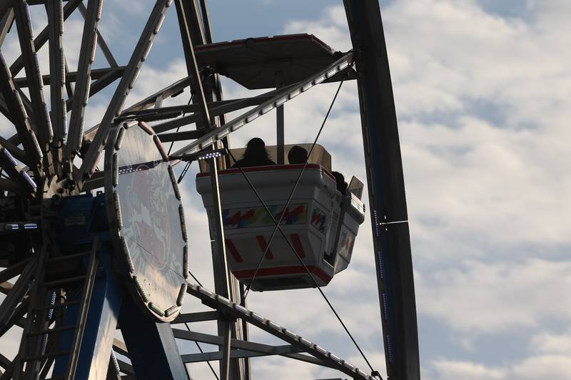 A family enjoys the view on the Ferris Wheel at the Taste of Joliet on Saturday, June 22, 2024 at Joliet Memorial Stadium.