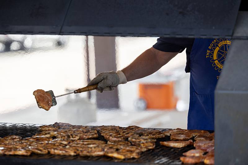 2,000 seasoned pork chops from The Butcher Shop in Sterling are being grilled up Monday, July 24, 2023 for the annual Rotary lunch time meal.
