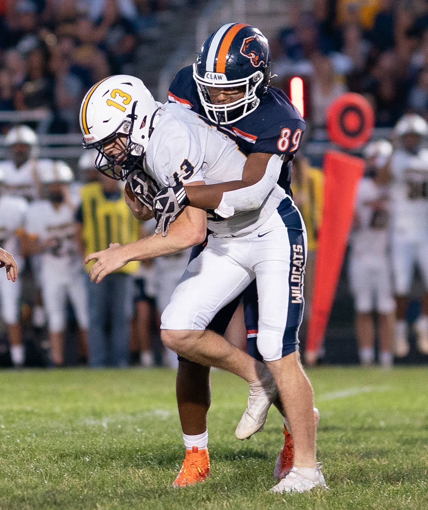 Neuqua Valley's Mark Mennecke (13) is tackled in the backfield by Oswego’s Taiden Thomas (89) during a football game at Oswego High School on Friday, Aug 26, 2022.