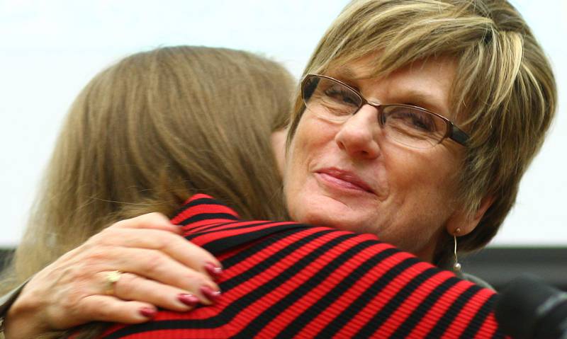 Judge Robbin Stuckert embraces DeKalb County Drug/DUI Court graduate Angela Tatroe, who just finished giving a speech thanking the people who supported her through the program in the Gathertorium room inside the DeKalb County Legislative Building in Sycamore, Ill. on Friday, Dec. 7, 2012.