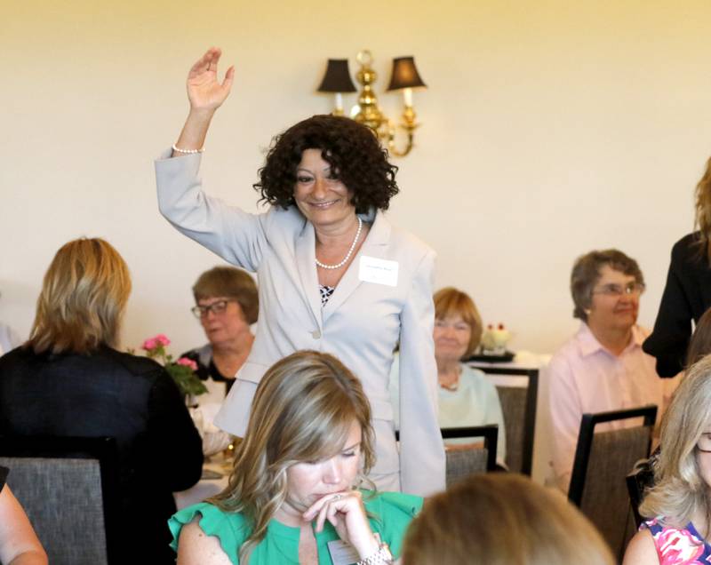 Award recipient Leonetta Rizzi waves to the crowd as she is introduced during the Northwest Herald's Women of Distinction award luncheon Wednesday June 5, 2024, at Boulder Ridge Country Club, in Lake in the Hills. The luncheon recognized 11 women in the community as Women of Distinction.