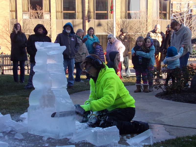 Spectators gathered at Heritage Park in Streator to watch a pair of ice sculptures get created Saturday, Nov. 25, 2023, during the Keeping Christmas Close to Home celebration.