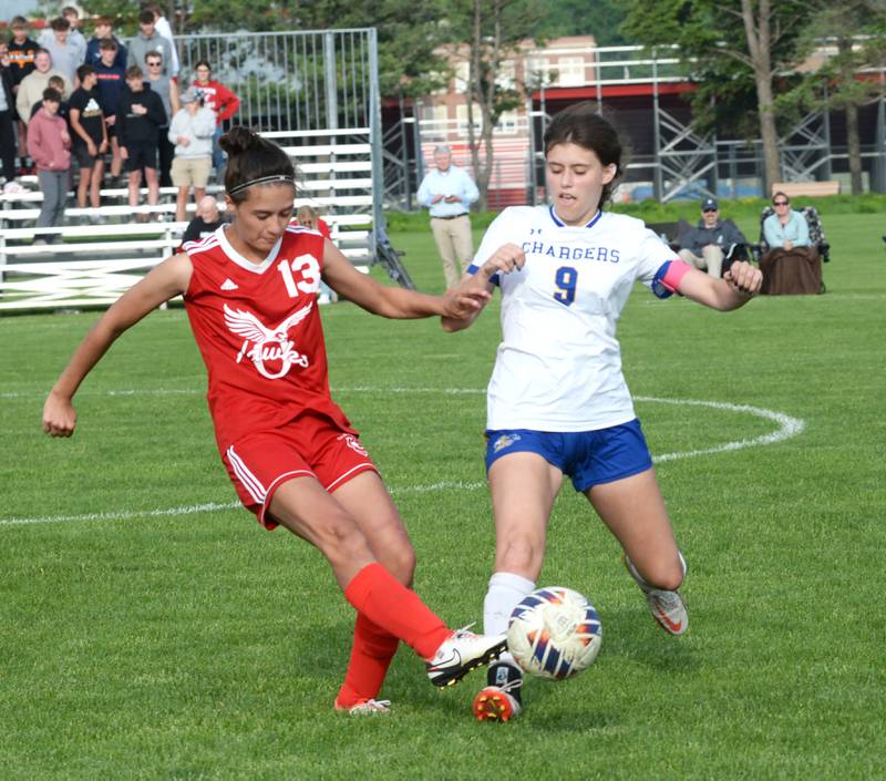 Oregon's Sarah Eckardt (13) clears the ball away from Aurora Central Catholic's Amanda Bush at the 1A Oregon Regional on Tuesday, May 14, 2024. Oregon won the game 4-1, advancing to the Shabbona (Indian Creek) Sectional on Saturday, May 18 where the  Hawks will face Stillman Valley in a noon game.