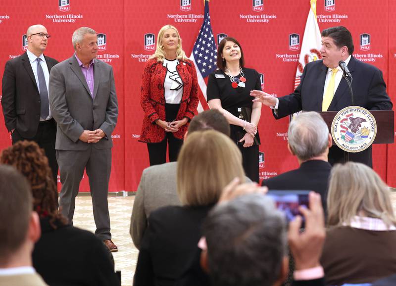 Gov. JB Pritzker, flanked by other state and local officials, speaks during a news conference Tuesday, April, 4, 2023, in the Barsema Alumni and Visitors Center at Northern Illinois University in DeKalb. Pritzker along with a group of llinois lawmakers, DeKalb city officials and representatives from NIU were on hand to promote the importance of funding higher education in Illinois.