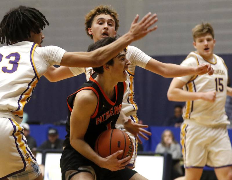 McHenry's Marko Visnjevac drives the lane between Hononegah's Darian Tholin (left)  and Hononegah's Landon Claudy during the IHSA Class 4A Guilford Boys Basketball Sectional semifinal game on Wednesday, Feb. 28, 2024, at Rock Valley College in Rockford.