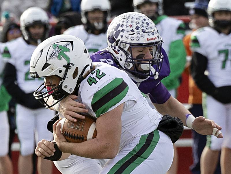 Athens’ Cory Craig Jr. is stopped by Wilmington's Dierks Geiss Friday, Nov. 24, 2023 in the 2A state football championship game at Hancock Stadium in Normal.