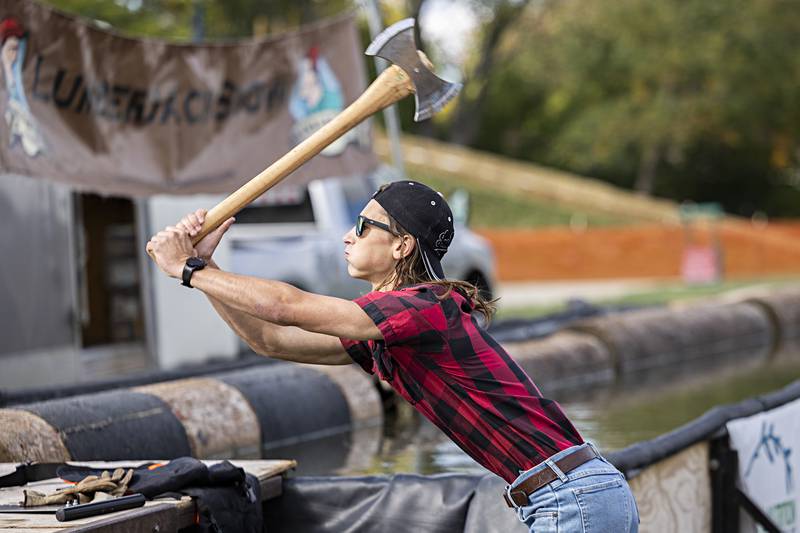 Brett Wells throws an axe Saturday, Oct. 7, 2023 during Rock Falls Tourism’s Lumberjack show. The show featured a competition of chopping, sawing, throwing and log balancing events held at Selmi’s Greenhouse and Farm Market.