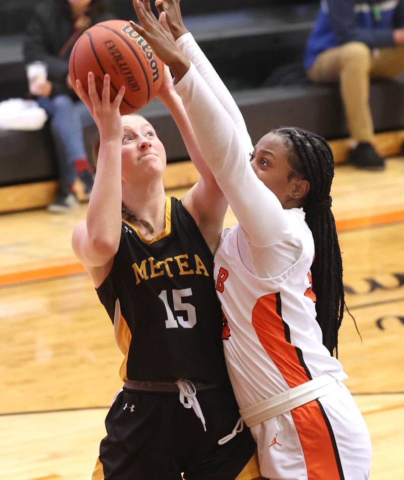 Metea Valley's Kelly Clish tries to shoot over DeKalb’s Cayla Evans during their game Friday, Jan. 19, 2024, at DeKalb High School.