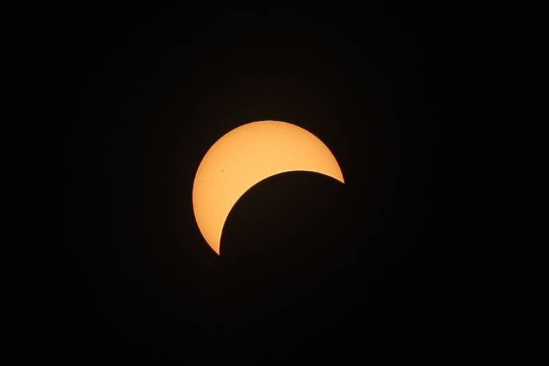 The moon passes in front of the sun at the Joliet Junior College solar eclipse viewing event on Monday, April 8, 2024 in Joliet.