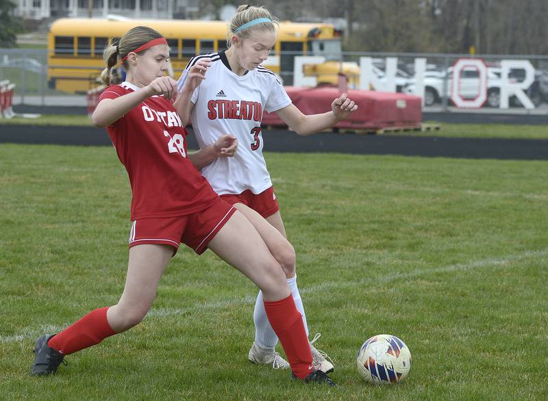Ottawa’s  Ayla Covalsky and Streator’s Joey Putz  work for control of the ball during the match Saturday at Ottawa.