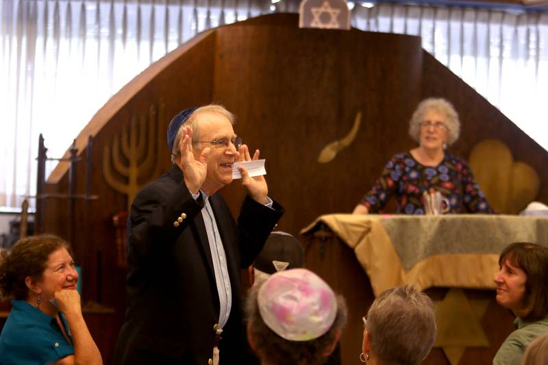 Bruce Weiss of Woodstock offers thanks to fellow congregation members as the McHenry County Jewish Congregation held a deconsecration ceremony at their Ridgefield Road location in preparation for a move to the Tree of Life Unitarian Church in McHenry on Sunday, August 18. Weiss is a founding member of the organization.