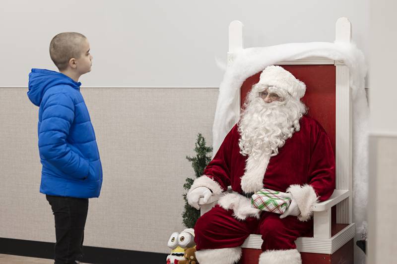 Connor Roland, 12, speaks with Santa Saturday, Dec. 10, 2022 during the annual Shop with a Cop in Dixon. 57 children were treated Saturday to a breakfast of lunch, allowed $175 to spend on gifts for themselves and loved ones plus were given coats, hats and mittens.