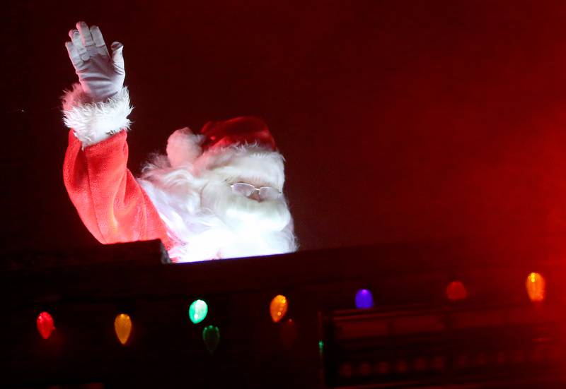 Santa Claus rides in a Utica Fire engine during the Utica Fire Department Santa parade on Saturday, Dec. 23, 2023. Santa took time out of his busy schedule to parade through most of the the Village of Utica bringing cheer to children of all ages. The Utica Fire Protection District has been hosting Santa since December 1941 and is one of the oldest Santa parades in the Illinois Valley. Each December, the Utica Fire Department escorts Santa throughout subdivisions and parades throughout the village.