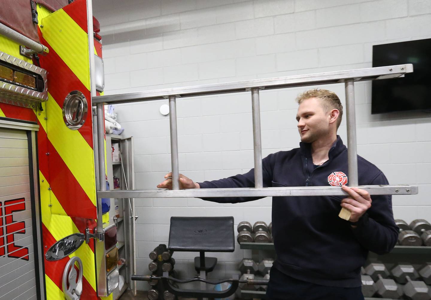 Ottawa firefighter and paramedic Adrian Banat, inspects a ladder at the Ottawa Fire Station off of State Street on Thursday, April 18, 2024 in Ottawa.