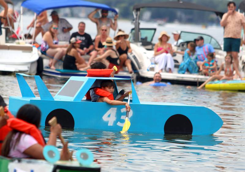 The Talladega Floats NASCAR-themed craft motors through the Cardboard Regatta on Crystal Lake Saturday.