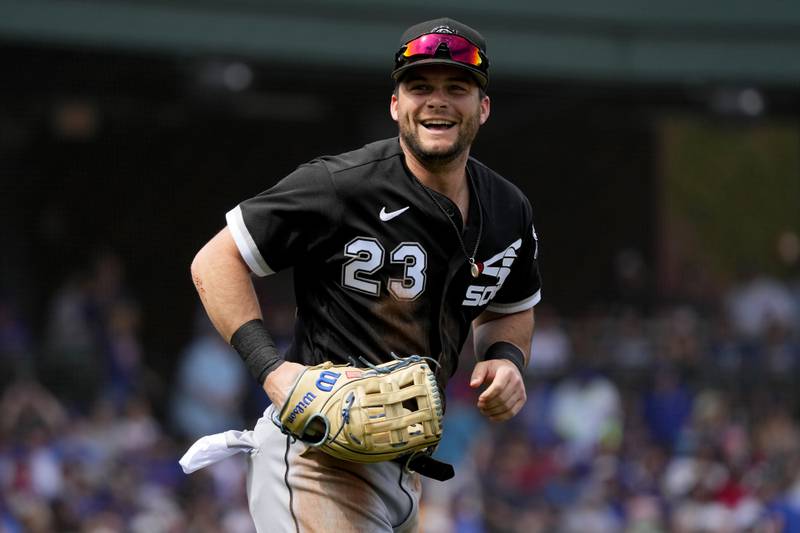 Chicago White Sox outfielder Andrew Benintendi smiles toward his bench after being called out at the plate during the first inning of a spring training baseball game against the Chicago Cubs, Friday, March 10, 2023, in Mesa, Ariz.