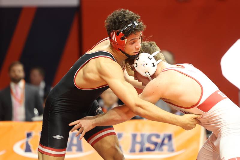 Barrington’s Rhenzo Augusto makes a move against Marist’s Will Denny in the 150-pound Class 3A state championship match on Saturday, Feb. 17th, 2024 in Champaign.