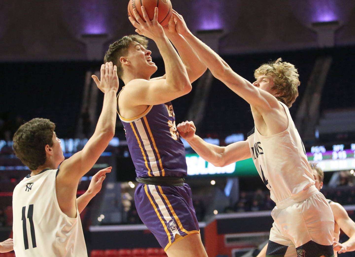Downers Grove North's George Wolkow looks to shoot a jump shot as North Trier defenders Evan Kanellos and Ian Brown defend in the Class 4A state third place game on Friday, March 10, 2023 at the State Farm Center in Champaign.
