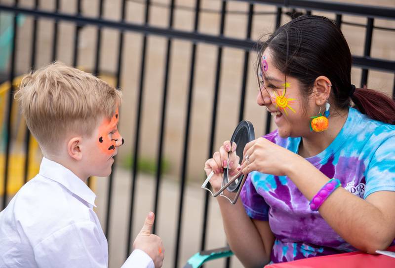 Braxton Hunter, 8, gives a face painter a thumbs up during DeKalb’s first Cinco de Mayo celebration co-hosted by Willrett Flower Co. on Third Street as part of the return of First Fridays in DeKalb on Friday, May 5, 2023.