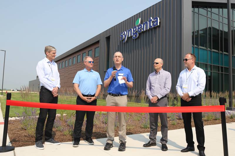 Warren Kruger, head of field crops seeds development for North America at Syngenta, speaks, flanked by Erik Fyrwald, (l-r) chief executive officer for the Syngenta Group, Eric Boeck, head of marketing for Syngenta Seeds, Trevor Hohls, global head of seeds development and Justin Wolfe, president of Syngenta Seeds Friday, June 23, 2023, during the grand opening of the Syngenta Seeds Research and Development Innovation Center in Malta.