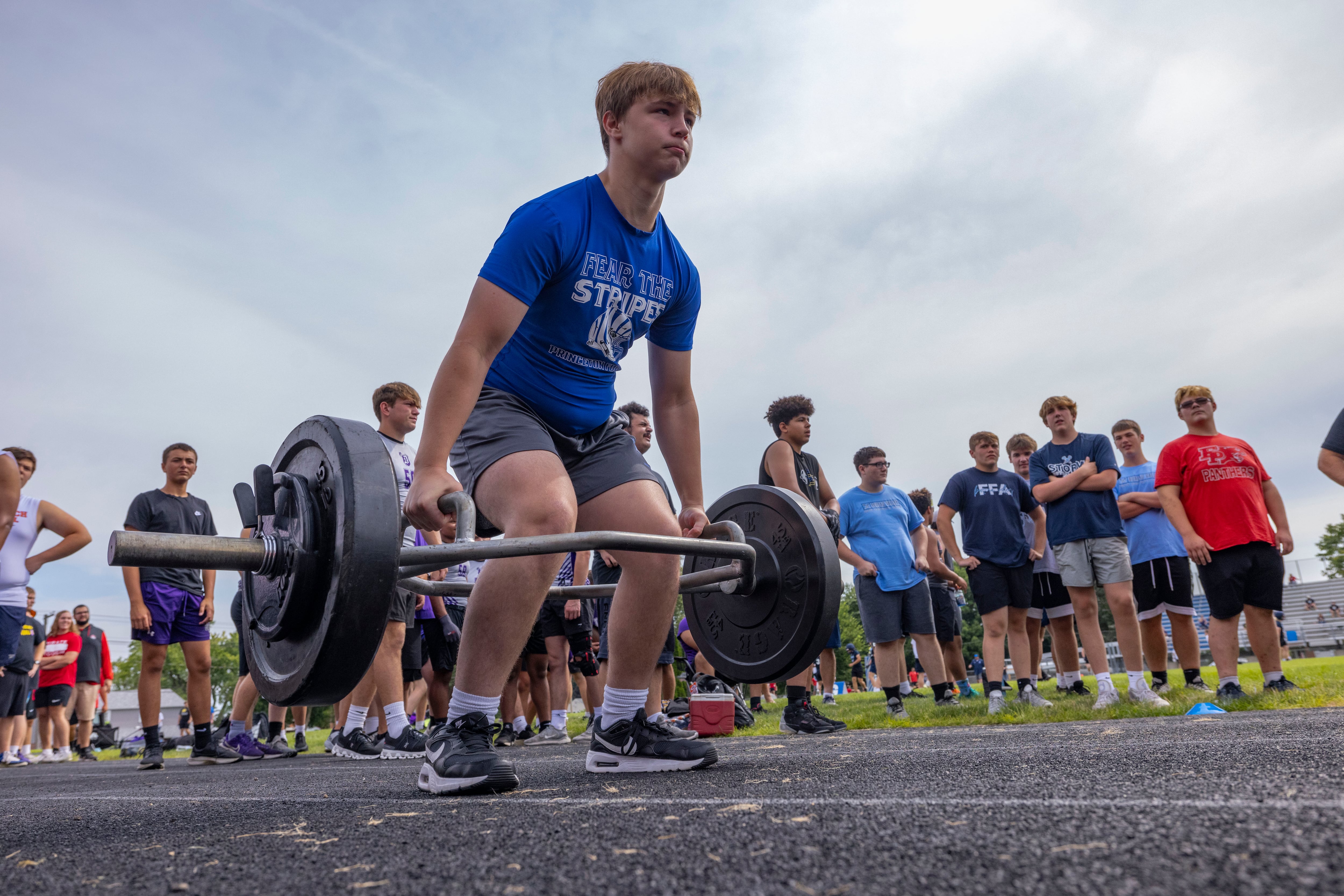 Daelen Brzezinski of Princeton High School competes in the Farmer's Carry during a multiple high school practice football meet at Princeton High School on July 20, 2024.