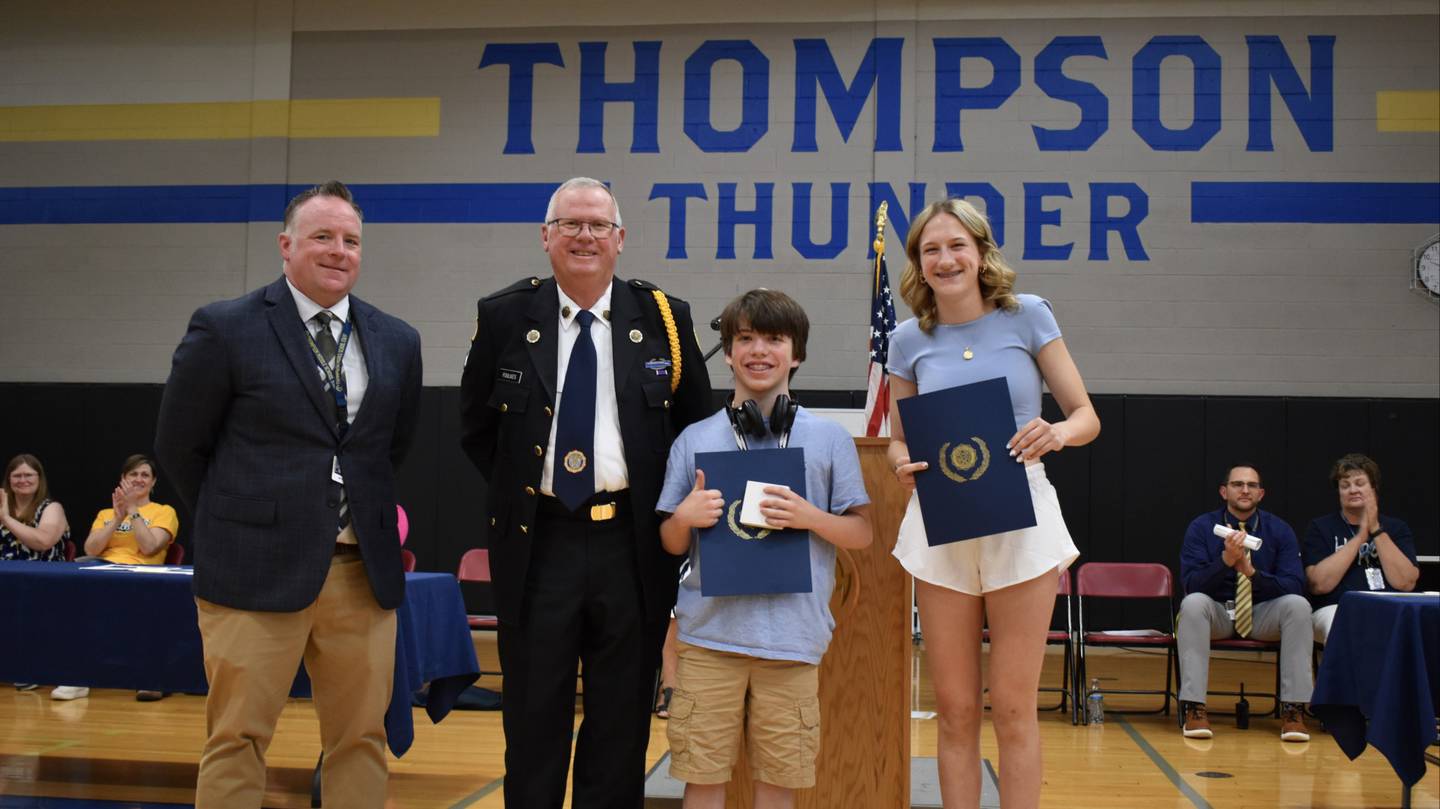St. Charles American Legion Post 342 member Mike Foulkes presents Thompson Middle School students Logan Kline and Francesa Fevold with the American Legion School Award at the 8th grade awards ceremony on May 30, 2024.
 (From left:  Thompson Middle School Principal Matt Clark, Foulkes, Kline and Fevold)