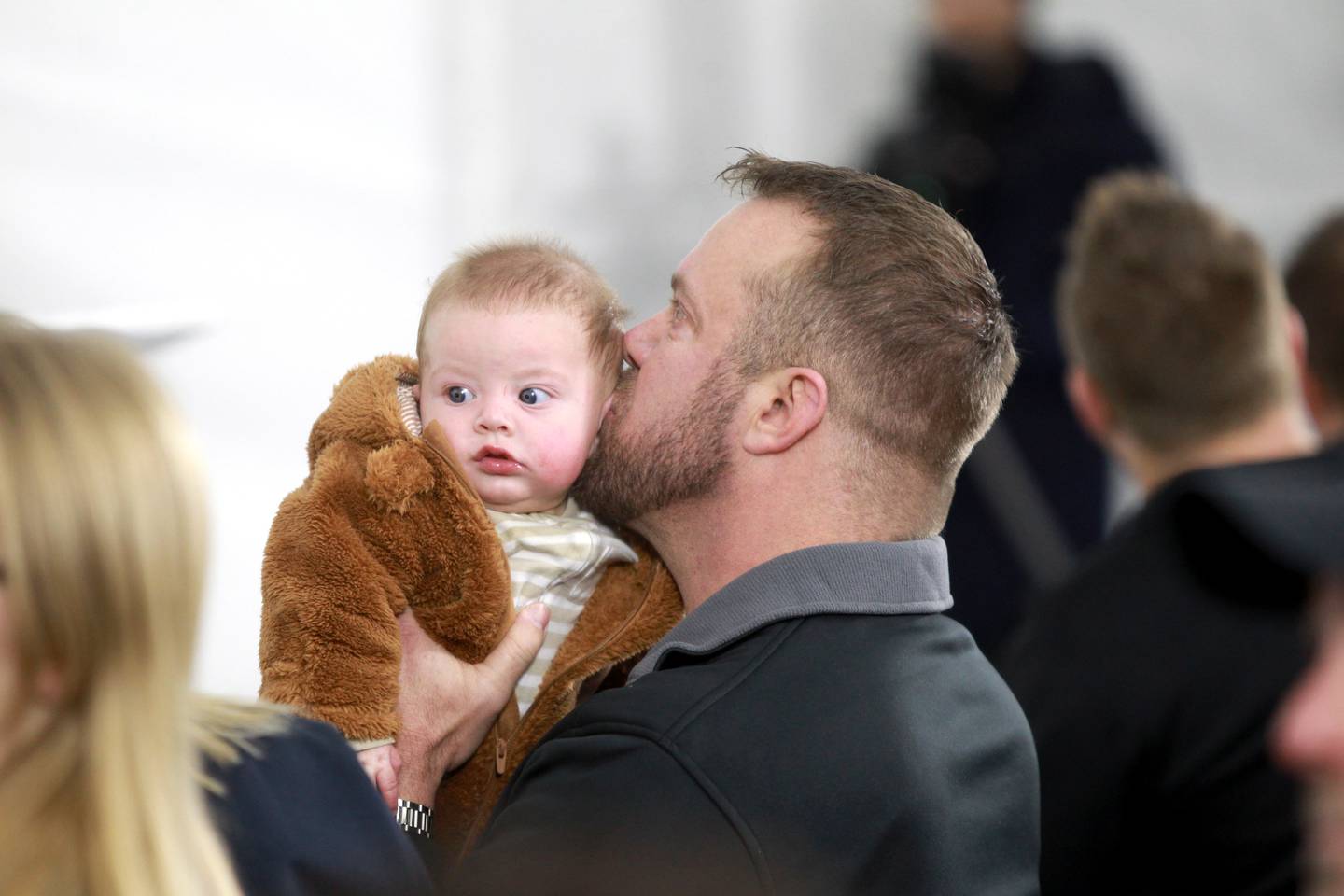 Retired U.S. Army Chief Warrant Officer 2 Patrick Scrogin kisses his infant son, Wyatt, during a dedication for his family’s newly constructed, specially adapted smart home in St. Charles on Thursday, Jan. 18, 2024. The mortgage-free home was made possible by the Gary Sinise Foundation.