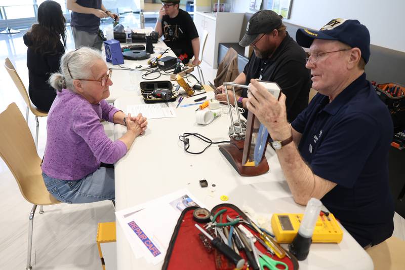 Peter Kiefer, a retired JJC teacher, right, repairs a lamp during the Repair Cafe event at the Joliet Junior College Romeoville campus on Saturday, April 13, 2024.