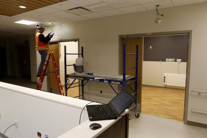 A construction worker installs call lights on Friday, April 21, 2023, as construction continues on the new Mercyhealth hospital in Crystal Lake. The hospital is ramping up hiring as it gets set to open in this summer.