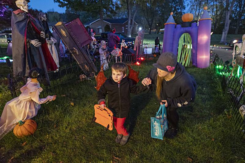 Colton Morgan, 4, walks with mom Ashley up to trick or treat at a home in Dixon Tuesday, Oct. 31, 2023.