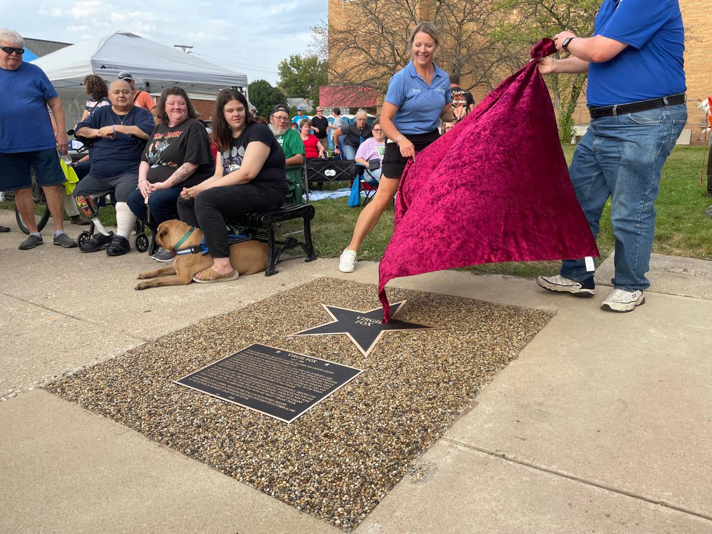 Theresa Wittenauer (left), Princeton city manager, and Lex Poppens, executive director for the Bureau County History Center, lift a pallet to expose the star honoring virtuoso Virgil Fox on Thursday, Sept. 5, 2024. Fox was a Princeton native who earned international acclaim as an organist and recording artist.