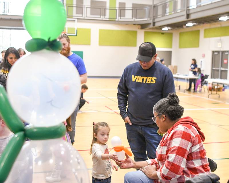 Ollie Virto, 2, and Philip Juarez, get a balloon snowman during the Sycamore Park District's Fire and Ice Festival on Saturday, Jan. 13, 2024, held at Sycamore Park District Community Center.