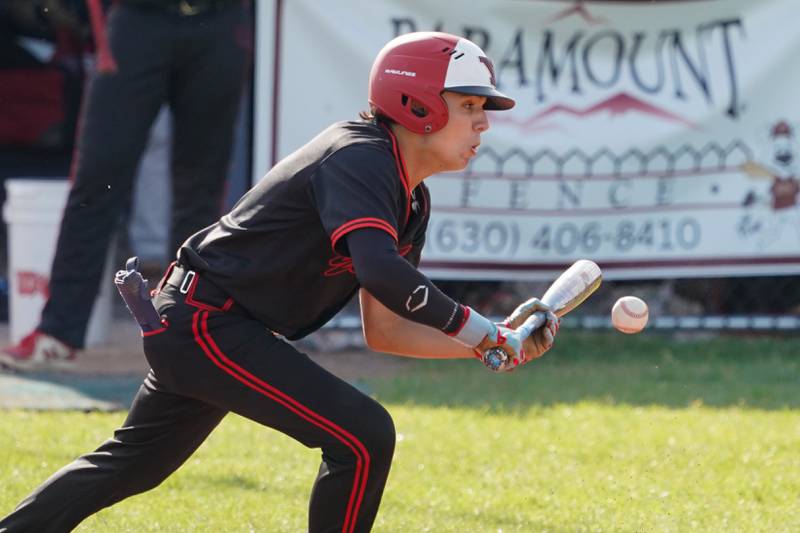 Yorkville's Nicholas Parashis (5) hits a bunt single against Neuqua Valley during a Class 4A Neuqua Valley Regional semifinal baseball game at Neuqua Valley High School in Naperville on Thursday, May 23, 2024.