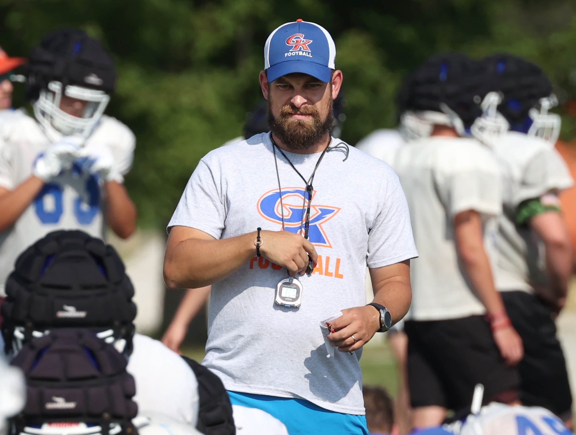 Genoa-Kingston head coach Cameron Davekos watches his team during practice Wednesday, Aug. 14, 2024, at the school in Genoa.