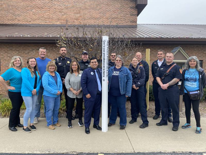 Lockport Township officials, first responders, and residents pose with the newly installed Peace Pole at the township office on Nov. 8.