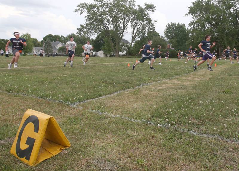 Members of the Fieldcrest football team sprint toward the goal line whle working on drills on Monday, July 8, 2024 at Fieldcrest High School.