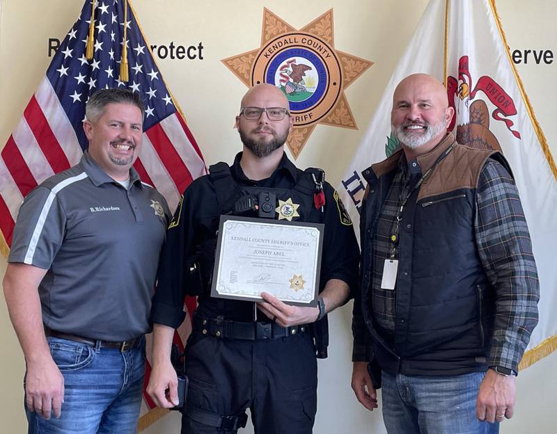 Kendall County Sheriff’s Office Employee of the Third Quarter Deputy Joseph Abel, pictured center, with Undersheriff Bobby Richardson, left, and Sheriff Dwight Baird.