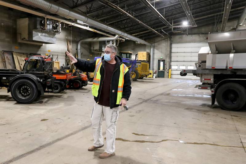 Village of Algonquin Public Works General Services Superintendent Steven Ludwig gestures toward some of the vehicles occupying the facility in Algonquin on Nov. 25. The facility, located at 110 Meyer Drive, could become a COVID-19 vaccine distribution site with ample room indoors to accommodate multiple workplaces for health department staff to collect information and administer a vaccine. Vehicles currently residing inside the structure will be relocated outside if necessary.